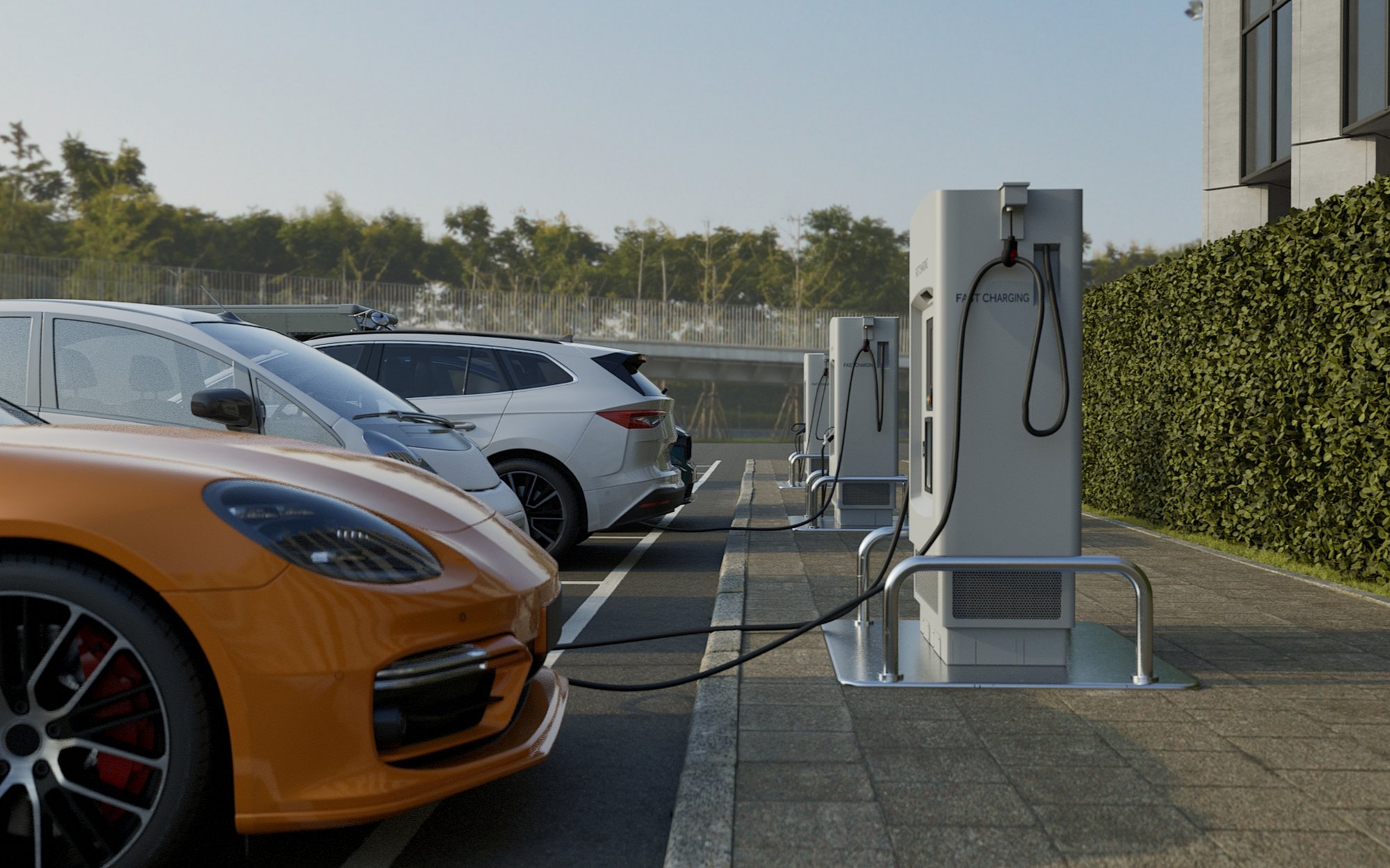 Multiple electric cars are charging at outdoor charging stations in a parking lot.