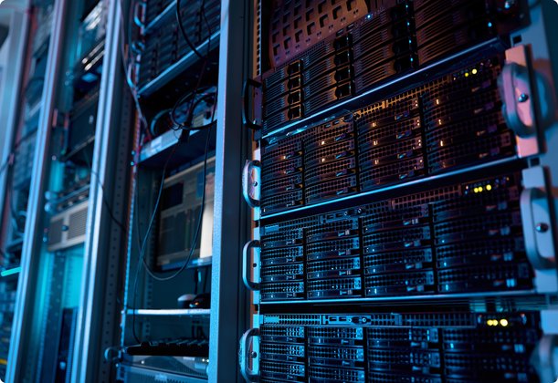 A detailed view of rows of high-tech server racks in a data center, with glowing lights symbolizing activity and the complexity of IT infrastructure.