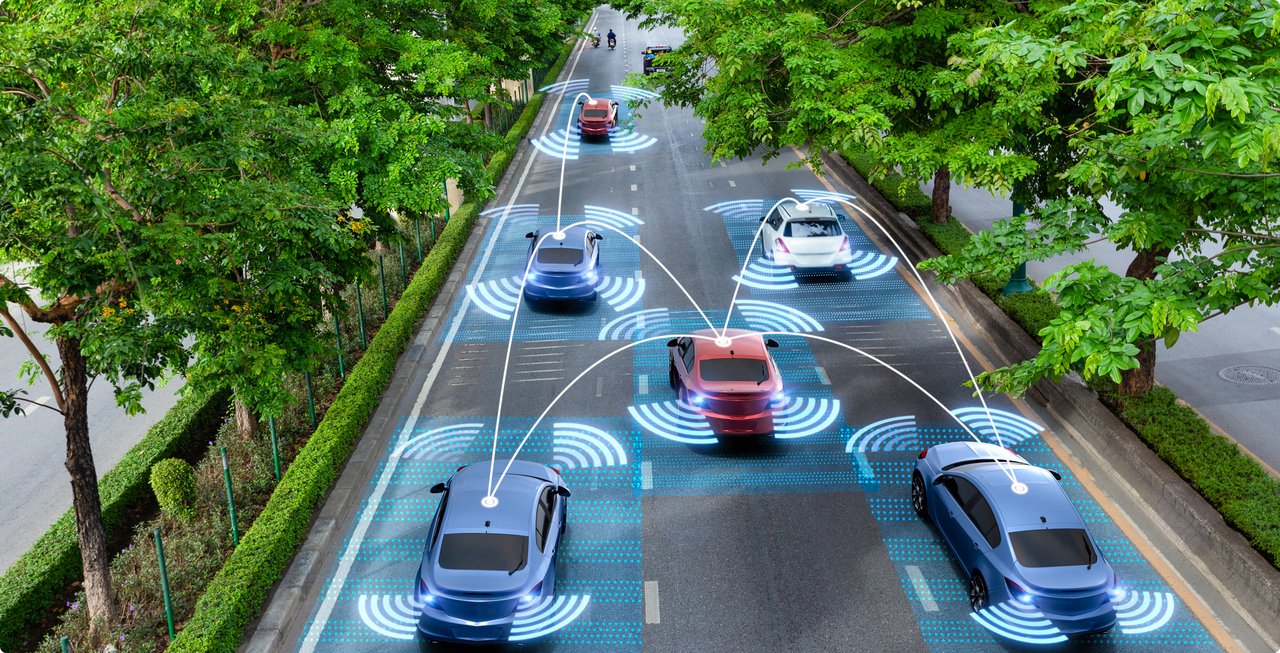 Top-down view of a tree-lined road with multiple cars driving, connected by glowing, wavy lines, symbolizing connectivity and autonomous driving functions.