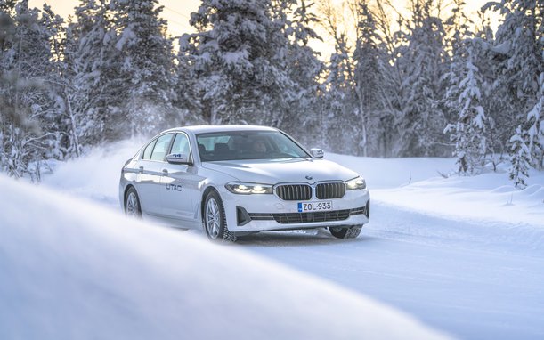 Car driving through a snowy winter landscape – test or drive under winter conditions.