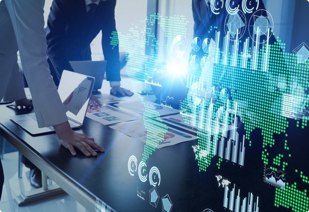 A group of people stands around a table with business documents, while an superimposed, glowing blue and green digital world map or data visualization emphasizes the global aspect and technology in their meeting.
